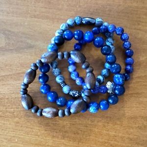 A bundle of 4 accessory bracelets. 1 wooden, 3 assorted(color, size stones)